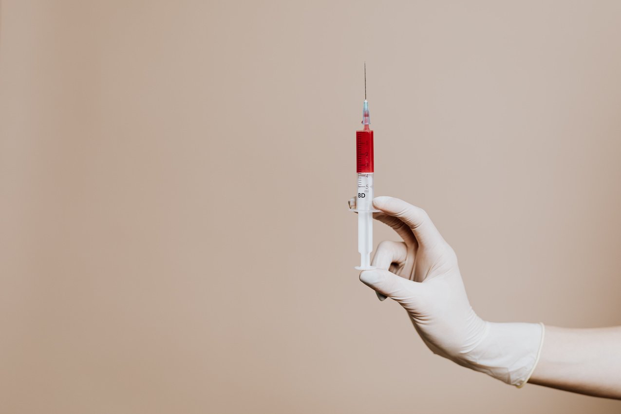 Photo Of Person Holding Syringe